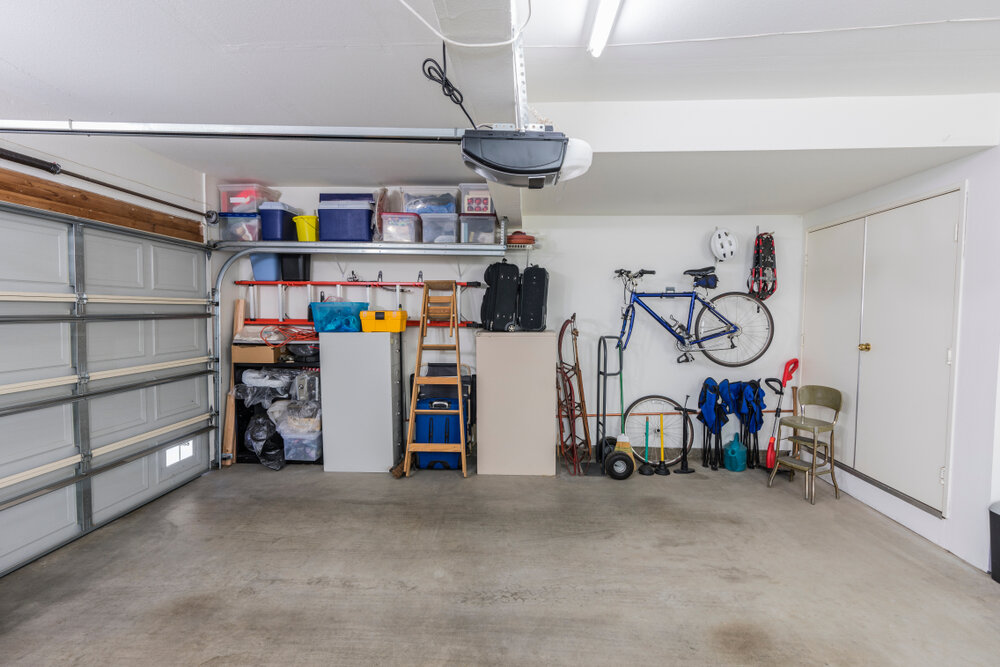 Partial garage with organized storage and parking space